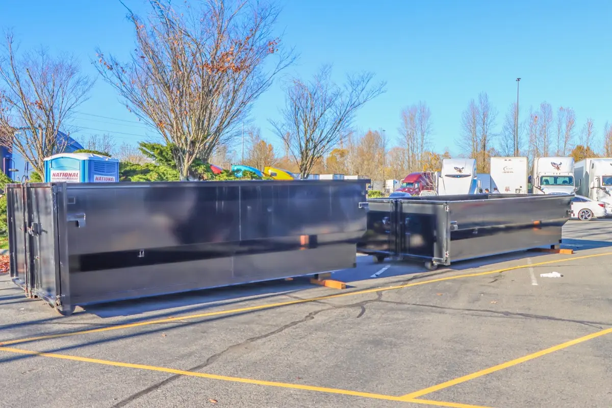 Professional dumpster rental service with roll-off container on residential driveway in Cynthiana